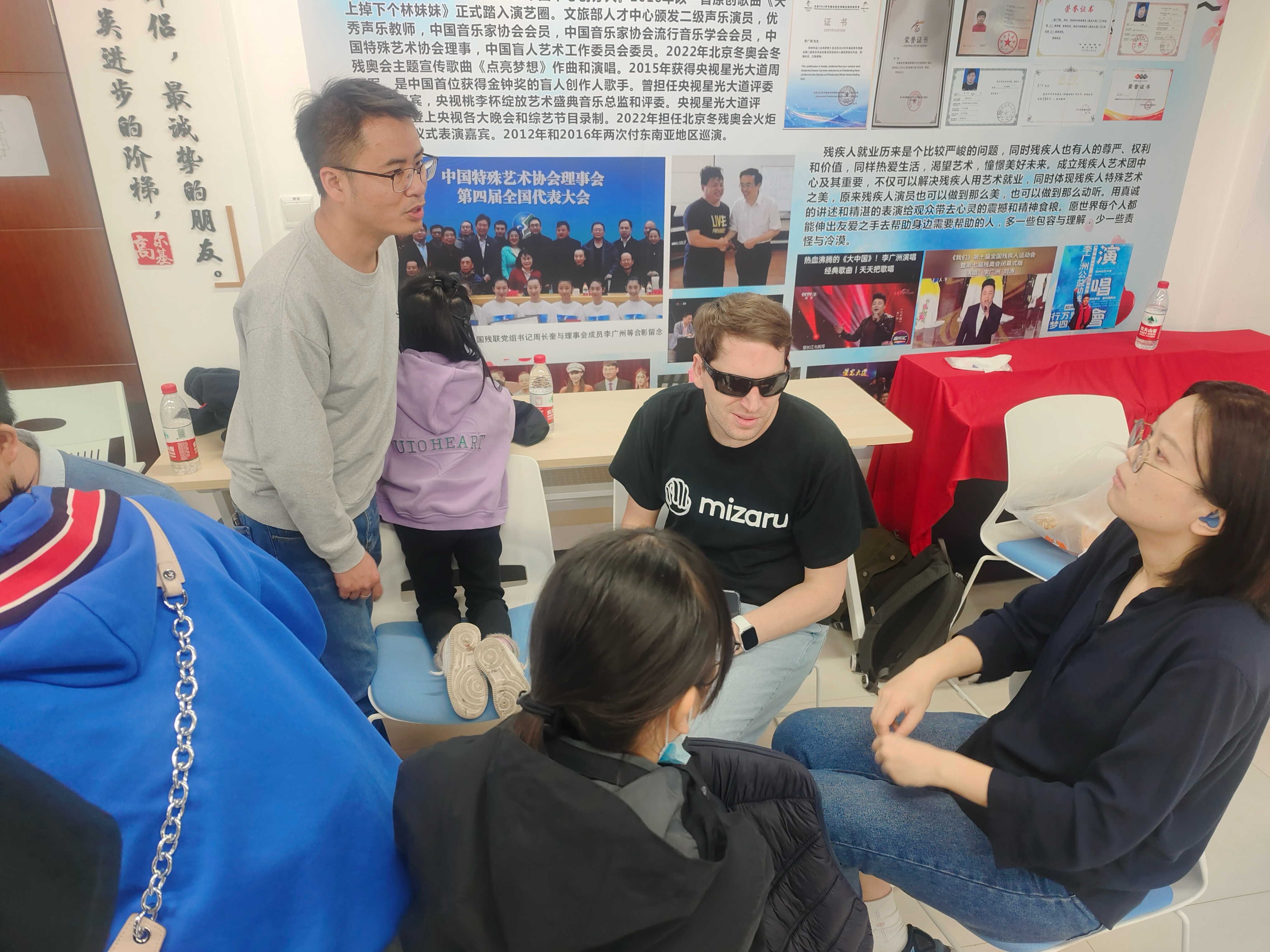 Participants engaged in collaborative discussion and communication during a community-focused accessibility session.